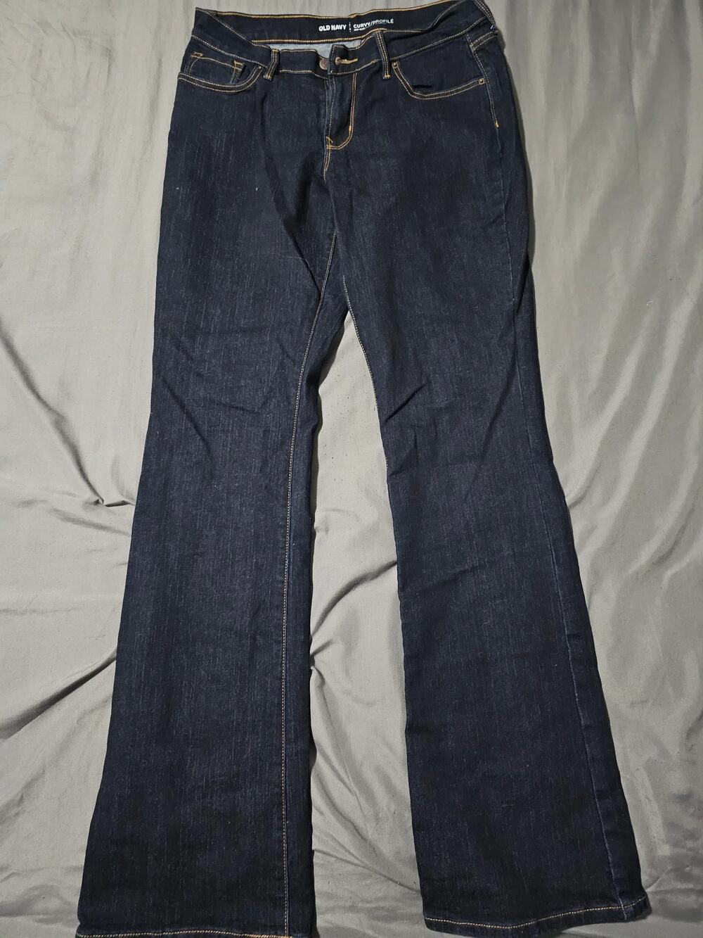 Dark wash denim jeans with contrast stitching and straight leg fit